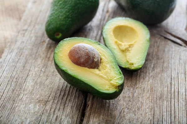 Avocados on a wooden background — Stock Photo, Image