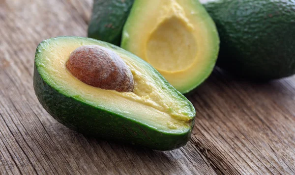 Avocados on a wooden background — Stock Photo, Image