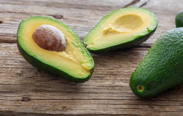 Avocados on a wooden background — Stock Photo, Image
