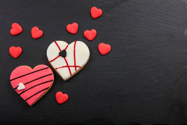 Heart shaped biscuits on a black background — Stock Photo, Image