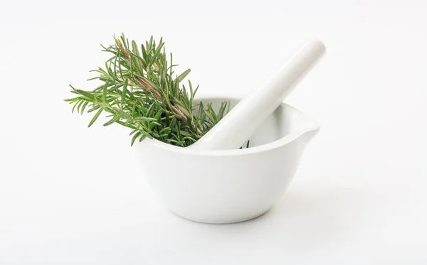 Rosemary in a mortar on white background — Stock Photo, Image