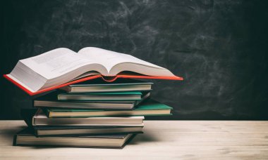Blackboard arka plan üzerinde kitap yığınları