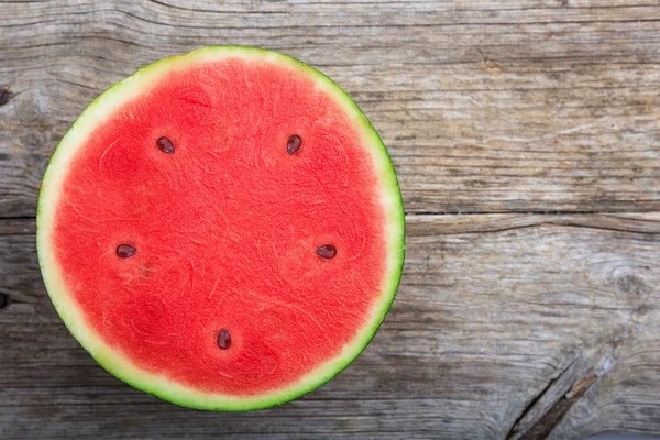 Half watermelon on a wooden table — Stock Photo, Image