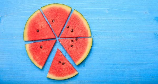 Watermelon pieces on a blue table — Stock Photo, Image