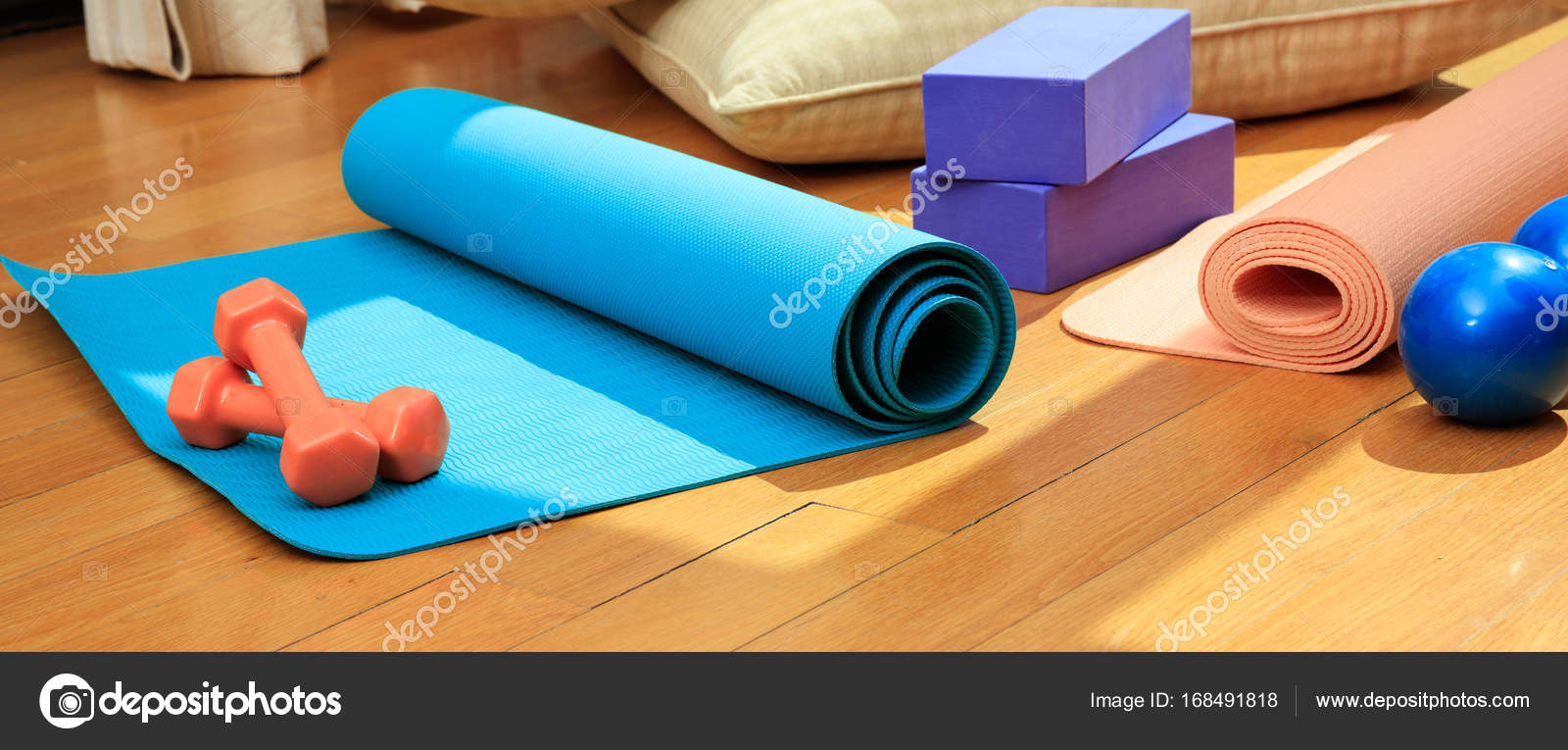 Yoga mat and exercise weights on wooden floor Stock Photo gioiak2 168491818