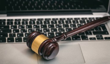 Auction or Judge gavel on a laptop clipart