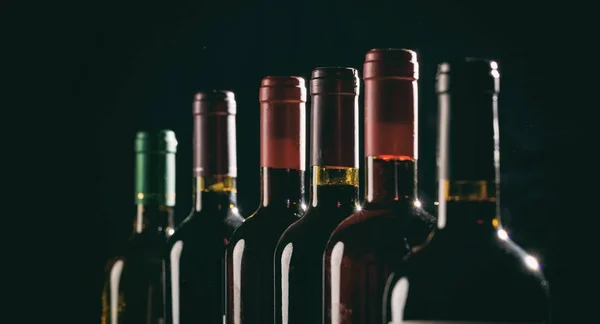 Wine bottles on black background — Stock Photo, Image