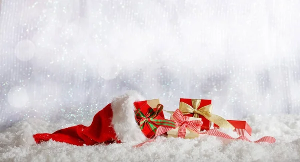 Красные рождественские подарочные коробки на рождественском снежном фоне — стоковое фото