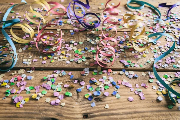 Renkli karnaval konfeti ve Serpantinli ahşap arka plan üzerinde