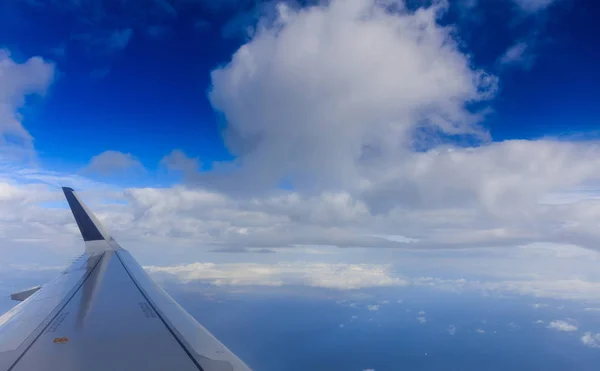 White clouds on a blue sky from a plane window background. Space for text. — Stock Photo, Image