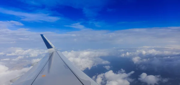 White clouds on a blue sky from a plane window background. Space for text. — Stock Photo, Image