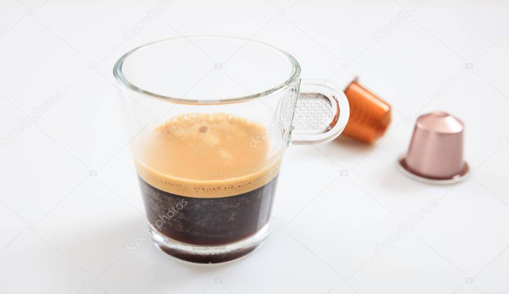 Espresso cup and coffee pods on white background, Closeup view with details