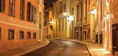 Plaka by night, Athens, traditional buildings at the sides of a street. Architecture in Greece. clipart
