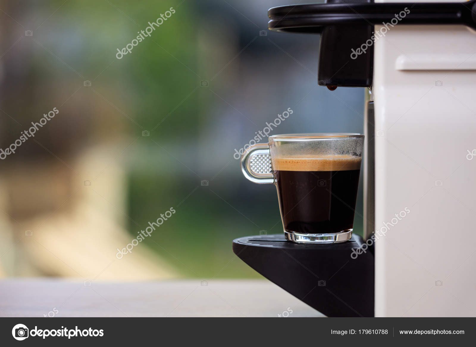 Espresso Coffee Machine On A Blur Green Background Space For Text