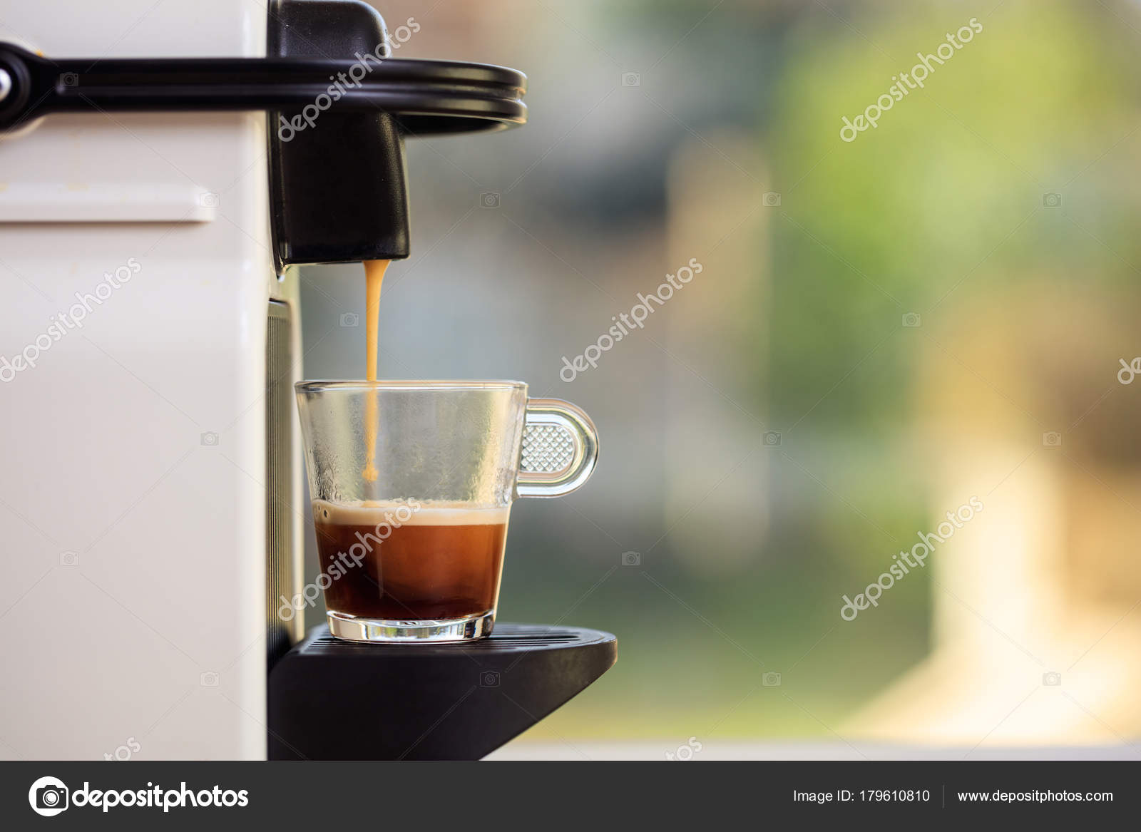 Espresso Coffee Machine On A Blur Green Background Space For Text