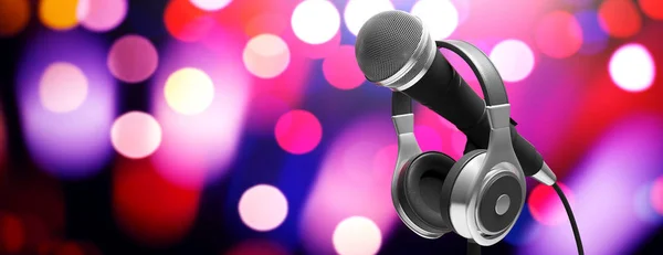 Live music concert concept. Microphone and headphones on stand on bokeh background, banner. 3d illustration