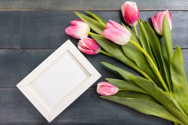 Bayan gün. Top görünüm pembe laleler ve mavi arka plan, kopya alanı, bir beyaz boş çerçeve