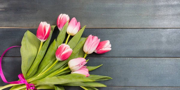 Mother\'s day. Pink tulips on blue background, copy space, top view