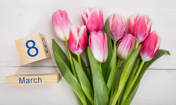 Women's day concept. Pink tulips and the March 8th date on white background — Stock Photo, Image