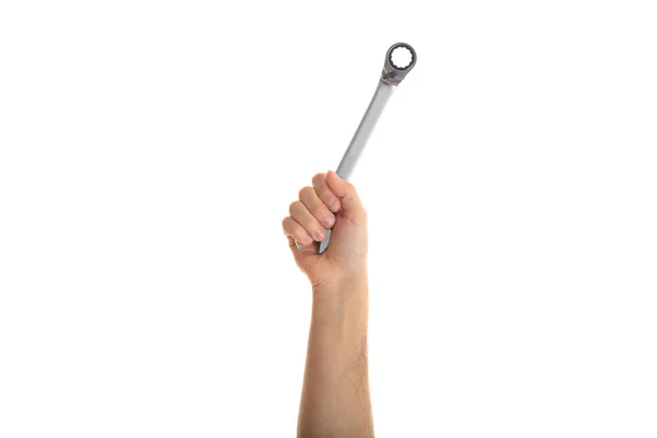 Mão segurando uma chave de metal no fundo branco — Fotografia de Stock