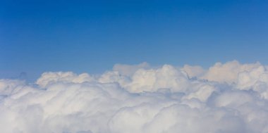Bulutların üstünde parlak mavi gökyüzü amaç, uçak penceresi görünümü