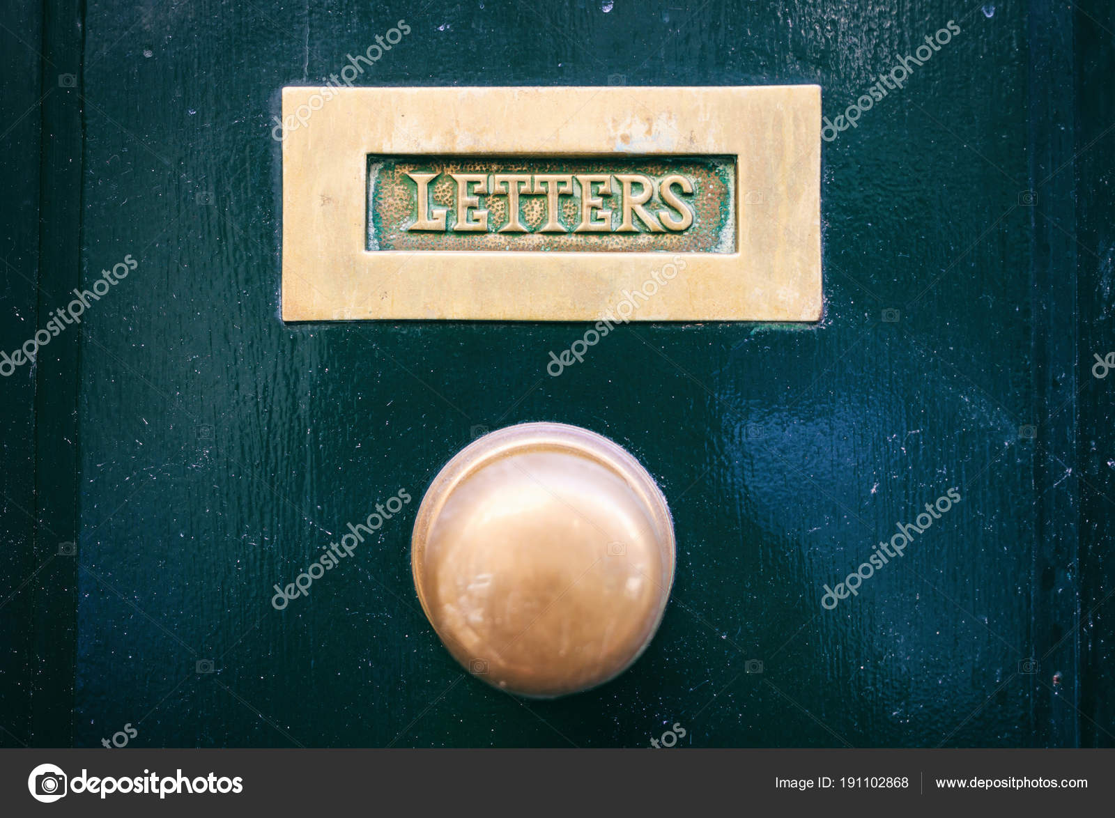 Old Brass Mail Letter Box And Knob On A Green Painted Front Door