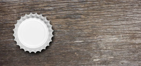 Glass beer bottle cap isolated on wooden background, top view, banner. 3d illustration