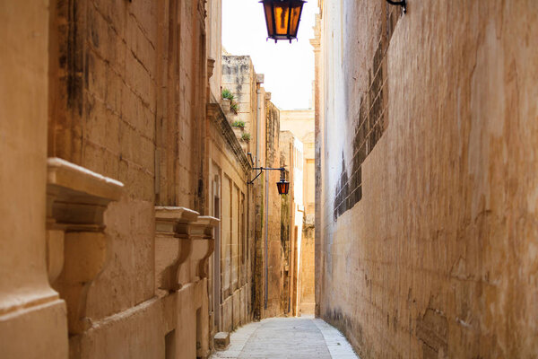 Mdina, Malta island. Old medieval city narrow streets, houses sandstone facades and lanterns