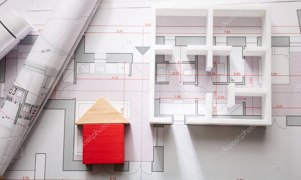 Construction concept. Residential building drawings and architectural model