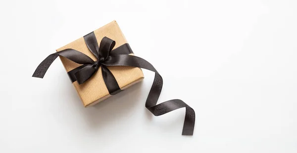 Gift box with black ribbon isolated against white background, Black Friday concept. — Stock Photo, Image