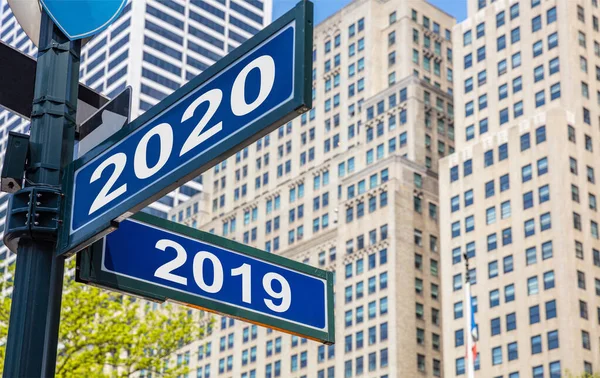 2020 new year and year 2019 Streets signs. Highrise buildings  background — Stok fotoğraf
