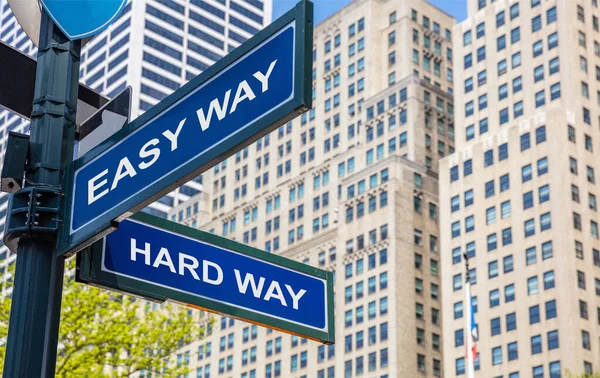 Easy way, hard way crossroads street sign. Highrise buildings background, — Stock Photo, Image