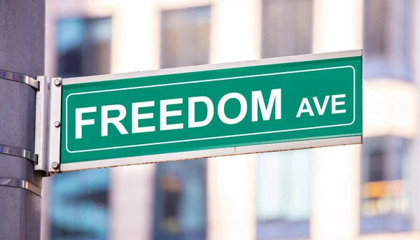 Liberdade anenue, sinal de rua centro da cidade. Blur edifícios fundo — Fotografia de Stock