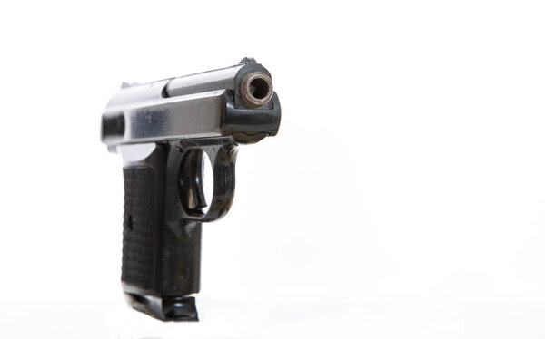 Handgun isolated against white background, closeup view