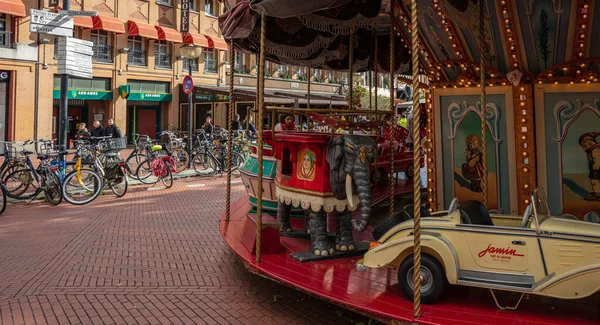 A vintage merry-go-round game in a paved square. Eindhoven, Netherlands. — Stock Photo, Image