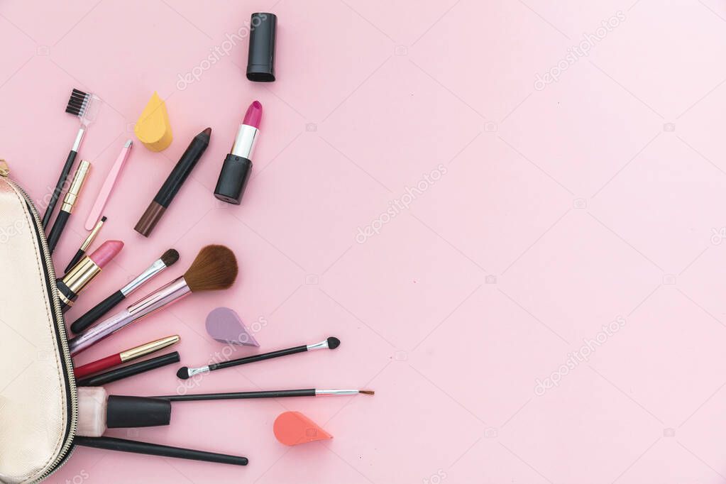 Make-up cosmetic bag against pink background, copy space