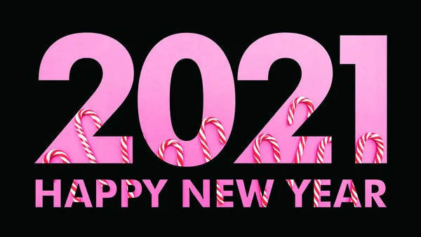 2021 Neujahr. Schwarze Papierschnittzahl 2021, Weihnachts-Zuckerstangen auf rosa Hintergrund. Frohes neues Jahr — Stockfoto