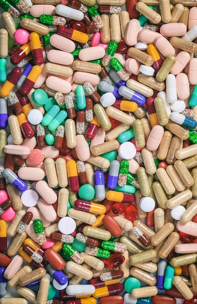 Health pharmacy concept. Medicine pills, capsules and tablets colorful background, texture. Top vertical view