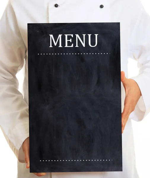 Restaurant menu blank black board. Chef with white uniform, holds an empty menu board, standing on white background. Copy space, vertical portrait.