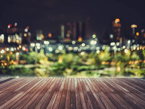 wooden table blurred sky night city building