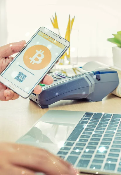 Man use smart phone pay with bitcoin
