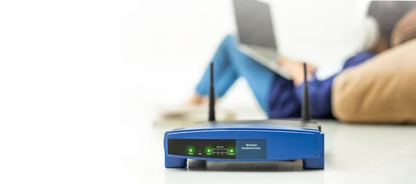 Wireless router and kids using a laptop in home. router wireless — Stock Photo, Image