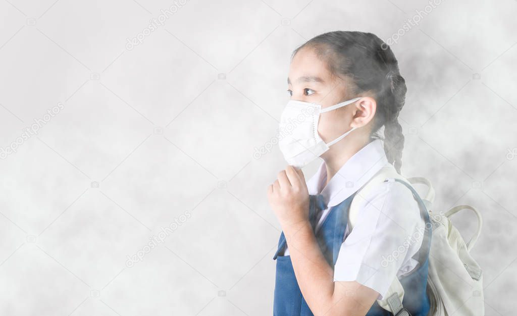 Portrait Asian children girl wear  mask to protect PM 2.5 dust a
