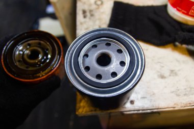 Bir araba motorunun yağ filtresini değiştirmek. yeni ve eski filtre