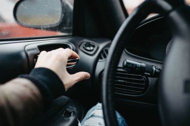 Erkek el, arabada otururken kapıyı açmak için düğmeye basar.