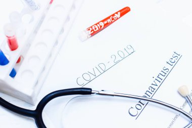 İçinde tıbbi test tüpleri ve steteskoplu Coronavirus testi olan kutu, bulaşıcı koronavirüsü önleme salgını konsepti