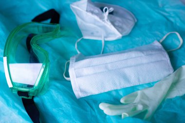 Gözlüklü koruyucu bir form ve epidemiyologun vardiyasından sonra eldivenli steteskop, koronavirüs konsepti.