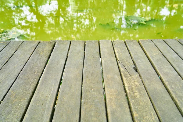 Wooden Floor and Green River — Stock Photo, Image