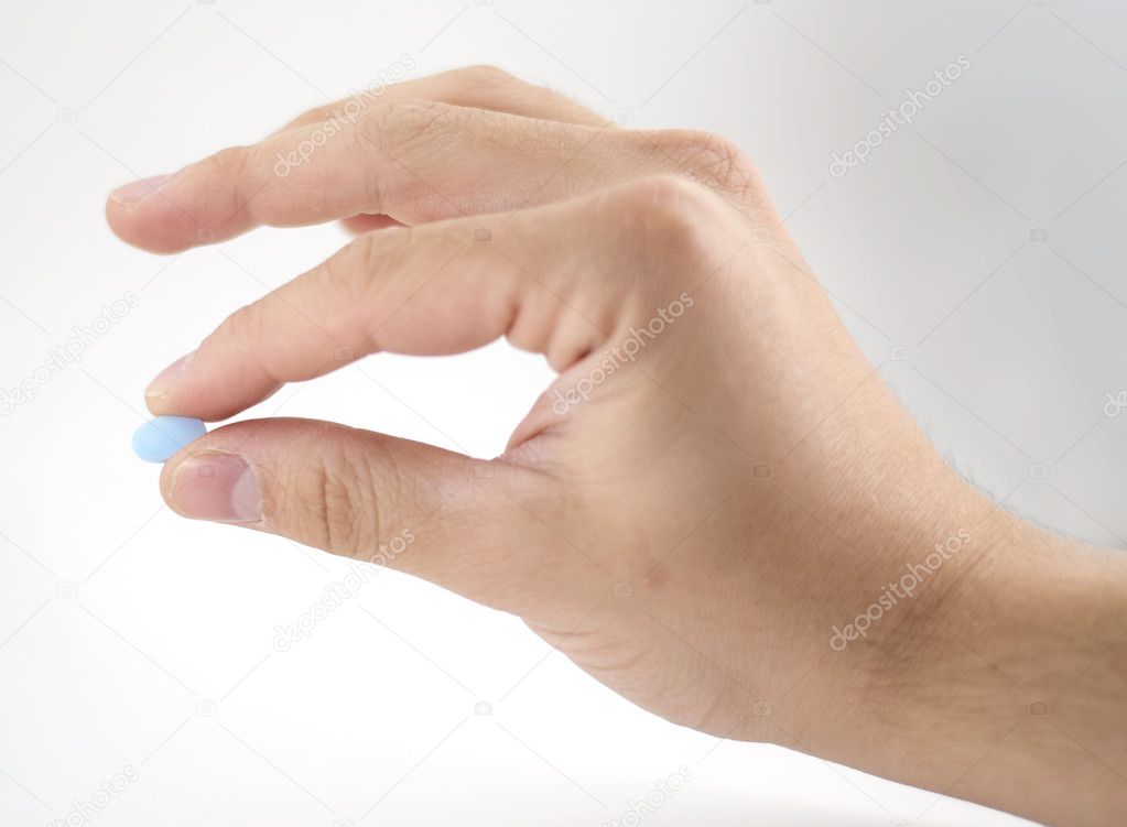 Male hand with blue pills