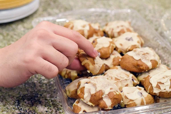 Hand picking up pumpkin cookie — Stock Photo, Image